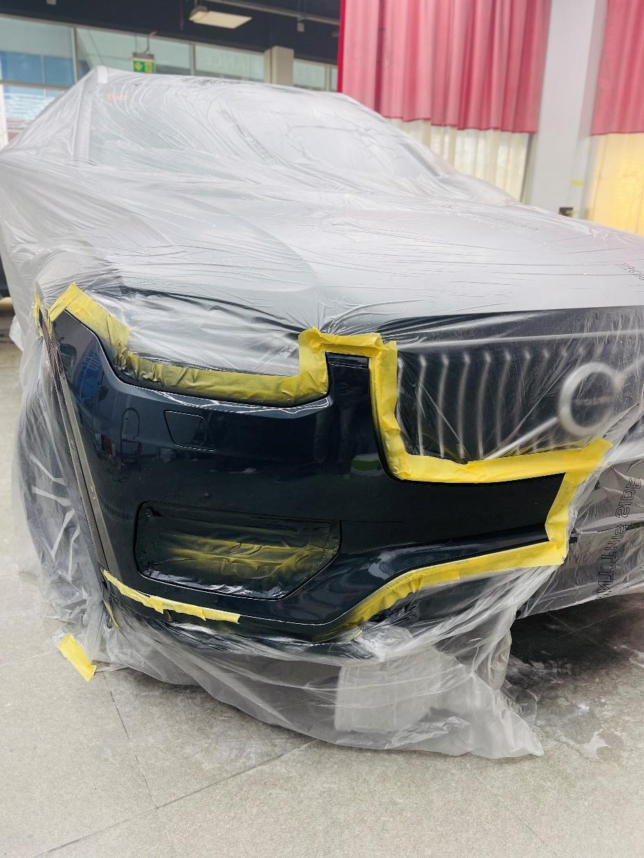 A car wrapped in sheets after the paint job