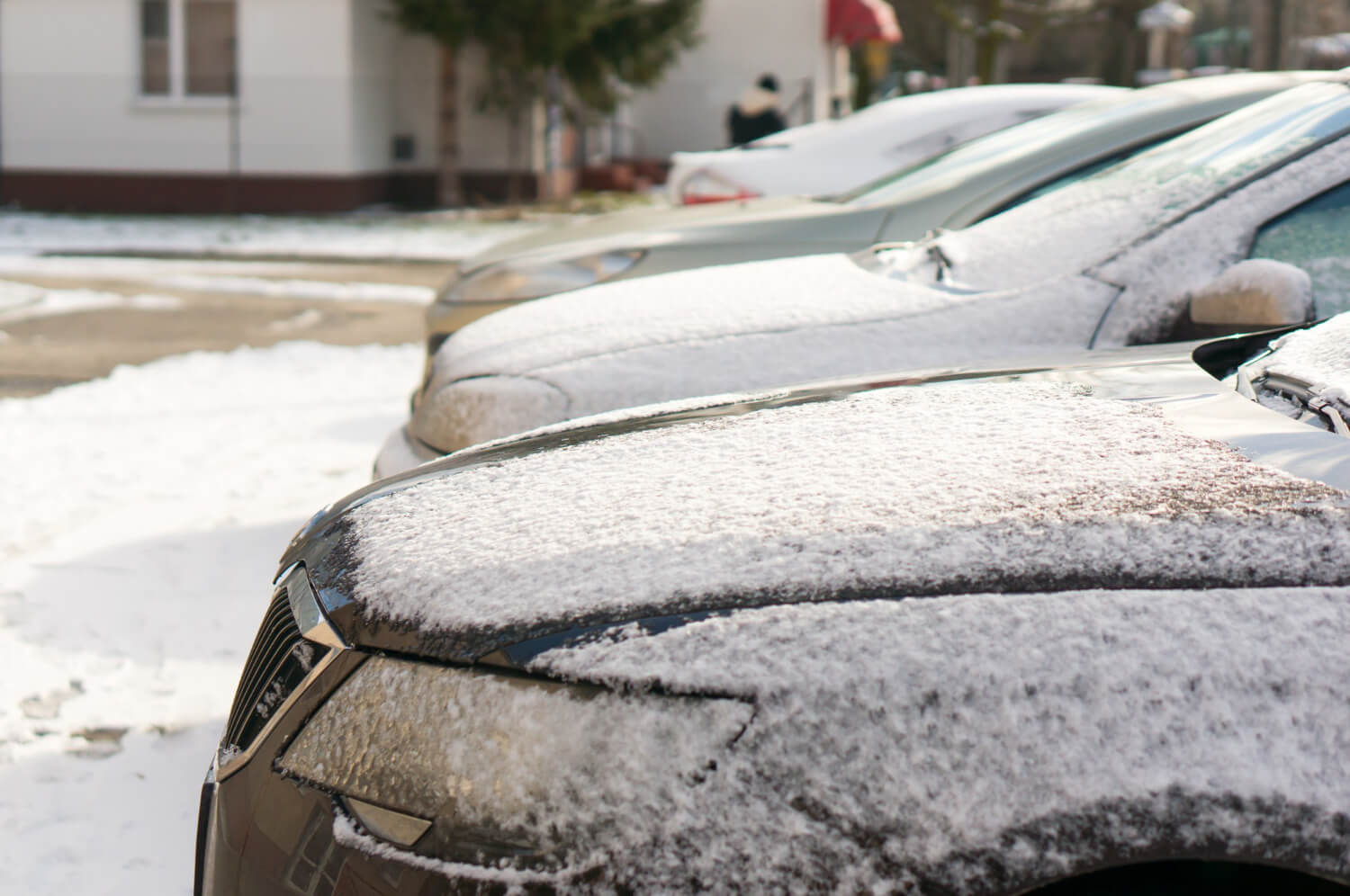 Cars with hail and snow frozen on the exterior